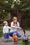 Family feeding chicken and duck on grassland