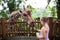 Family feeding giraffe in zoo. Children feed giraffes in tropical safari park during summer vacation. Kids watch animals. Little