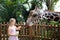 Family feeding giraffe in zoo. Children feed giraffes in tropical safari park during summer vacation. Kids watch animals. Little