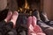 Family of Feet warming at a fireplace