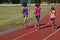 Family fitness, active mother and kids running on stadium track