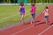 Family fitness, active mother and kids running on stadium track
