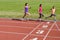 Family fitness, active mother and kids running on stadium track