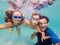 Family fitness - mother, father, baby son learn to swim together, dive underwater with fun in pool Active parent lifestyle, people