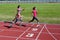 Family fitness, mother and kids running on stadium track, training and children sport healthy lifestyle