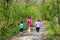 Family fitness and sport, active mother and kids jogging outdoors, running in forest