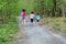 Family fitness and sport, active mother and kids jogging outdoors, running in forest