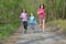 Family fitness and sport, active mother and kids jogging outdoors, running in forest