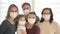 Family of five wears a protective medical mask to prevent coronavirus. Adults and children in medical masks to prevent