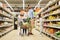 Family with food in shopping cart at grocery store