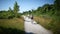 Family of four on a bicycle outing in an ecological park.