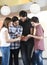 Family Of Four In Casuals Choosing Ice Creams From Menu