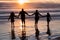 Family of four holding hands silhouettes