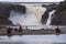 Family of four and other people enjoying the view of the impressive 115-foot tall ChaudiÃ¨re River Falls