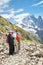 The family from four persons staying on trail in mountains