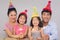 Family of four playing with firecrackers at a birthday party