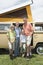 Family Of Four Standing By Campervan