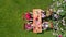 Family and friends eating together outdoors on summer garden party. Aerial view of table with food and drinks from above