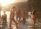 Family With Friends Enjoying Evening Swim In Countryside Lake