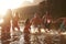 Family With Friends Enjoying Evening Swim In Countryside Lake