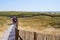 Family and friends go to the beach on wooden pathway in summer day