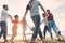 Family friends having fun on the beach at sunset - Fathers, mothers, children and uncles playing together - Love, relationship,