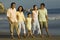 Family And Friends Walking On Beach