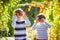 Family fun during harvest time on a farm. Kids playing in autumn garden