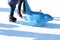 Family fun on outdoor ice rink, kid learning to skate with plastic seal as training aids