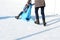 Family fun on outdoor ice rink, kid learning to skate with plastic seal as training aids