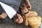 Family fun. Top view of positive father and little boy smiling to camera with moustache props, lying on grey carpet