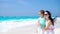 Family fun on white sand. Smiling mother and adorable child playing at sandy beach on a sunny day