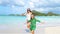 Family fun on white sand. Smiling mother and adorable child playing at sandy beach on a sunny day. SLOW MOTION