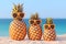 Family of funny attractive pineapples in stylish sunglasses on the sand against turquoise sea. Tropical summer vacation