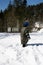 Family games in the snow in a forest glade. Adults and children in protective clothing. Carpathians. Ukraine.