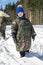 Family games in the snow in a forest glade. Adults and children in protective clothing. Carpathians. Ukraine.