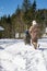 Family games in the snow in a forest glade. Adults and children in protective clothing. Carpathians. Ukraine.