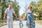 Family, generation and people concept - happy smiling grandmother, grandfather and little granddaughter walking at park