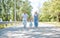 Family, generation and people concept - happy smiling grandmother, grandfather and little granddaughter walking at park