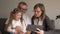 Family, generation, technology and people concept - smiling grandfather, granddaughter and grandmother with tablet