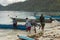 A family gets into a boat, ready to depart, Raja Ampat