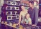 family with girl shopping gas-cooker in shop of household appliances