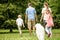 Family and girl walking dog