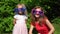 Family girls mother and daughter put on huge sun glasses and show finger up