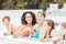 Family with glasses of juice in swimming pool