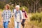 Family with grandmother walking through a forest together