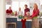 Family With Grandparents Preparing Christmas Meal In Kitchen