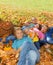 Family on the grass and basket with apples nearby