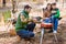 Family grilling meat on barbecue