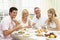 Family Group Enjoying Hotel Breakfast